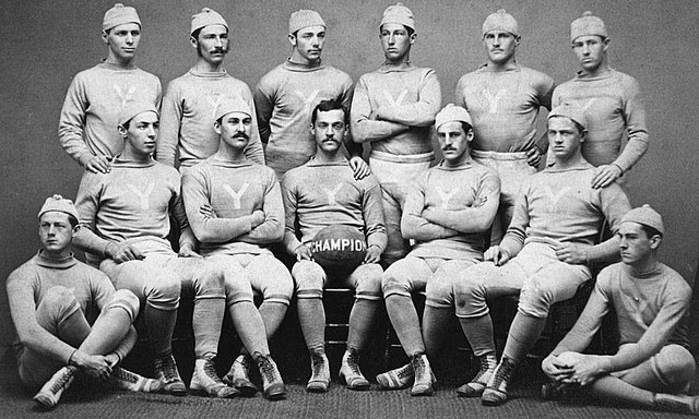 Yale University's men's champion football team of 1876, wearing uniforms consisting of jerseys, caps, kneepants, knee socks, and high-top laced shoes
